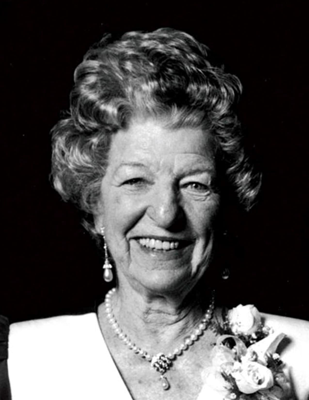 Black and white portrait of LeVert Hoag, smiling, wearing pearls and a corsage